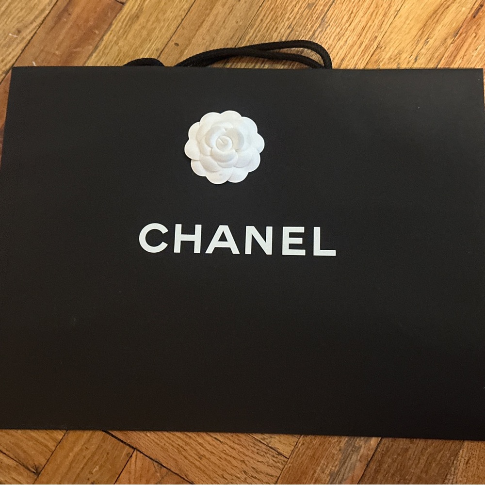 CHANEL Black Bag with White Flower Accent